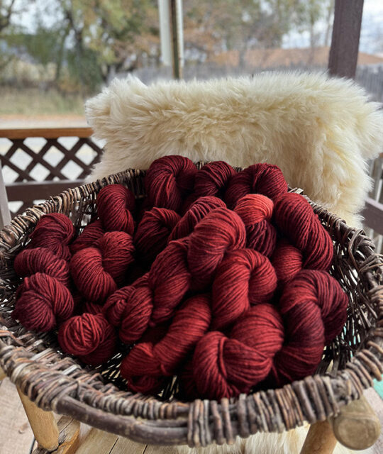 Basket of beautiful hand dyed hanks of yearn from Taos Wools.