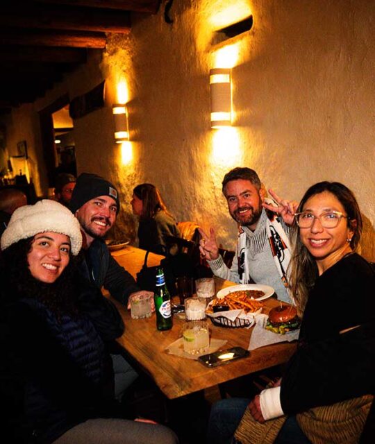 Two couples in winter ski wear enjoying apres.