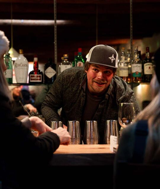 Friendly bartender working behind the bar at Saltos in New Mexico.