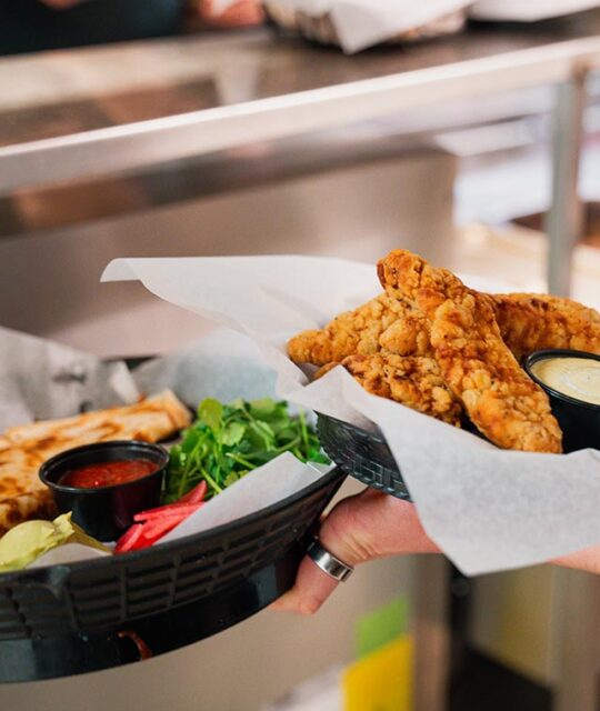 Quesadilla and chicken tenders in baskets ready to serve.