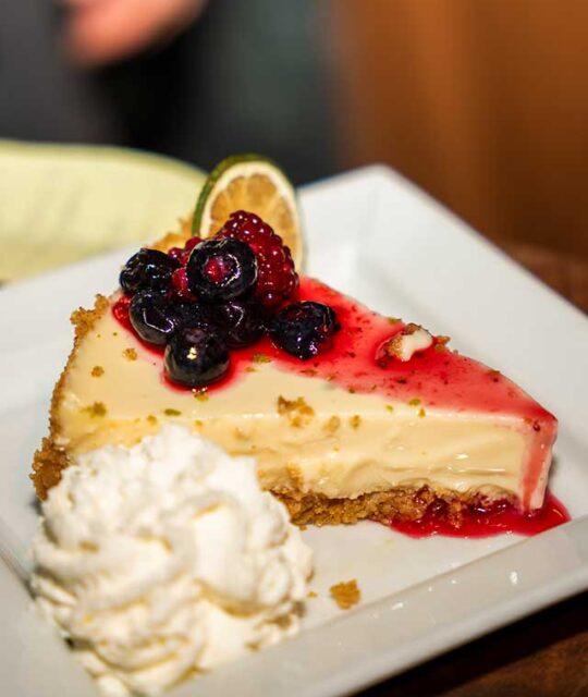 Cheesecake with berries and whipped cream.