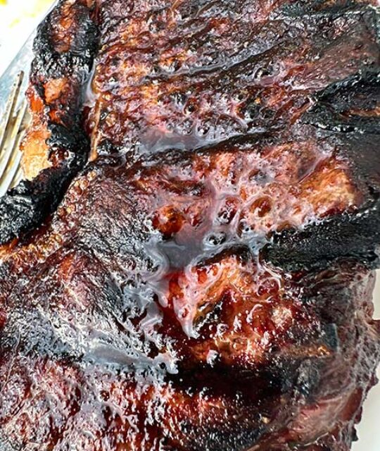 Close up of grilled steaks.