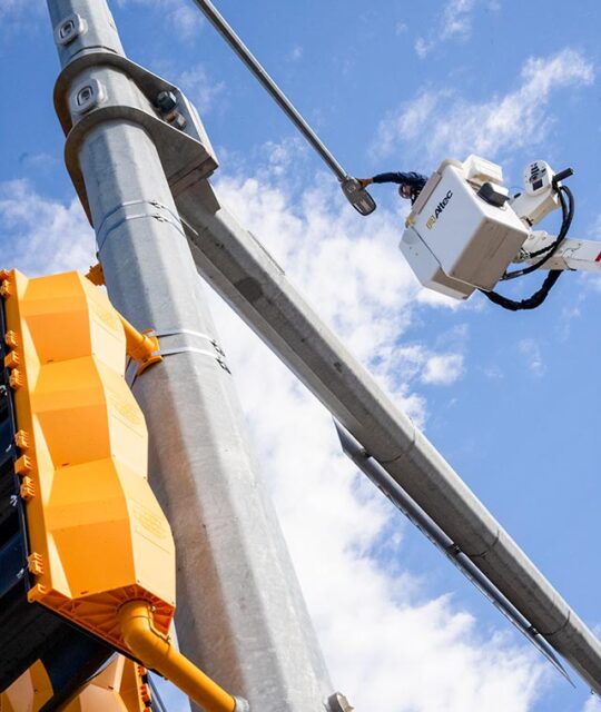 Lineman on a boom fixing a street light