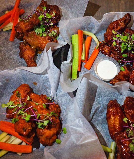 Baskets of chicken wings and veggie sticks ready to serve.