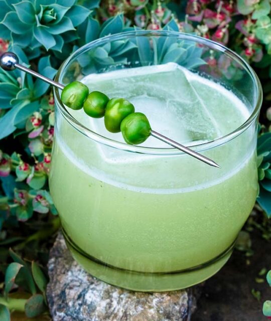 Sotol craft cocktail with English peas, mint, tarragon, lime