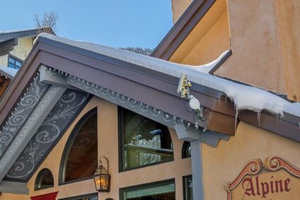 Alpine Village Suites entrance on a snowy day in Taos Ski Valley