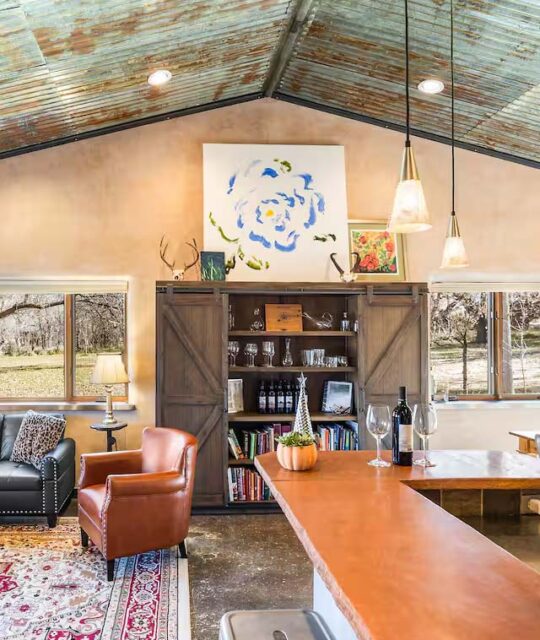 The morn rustic living and dining area of a winemakers home available for rent.
