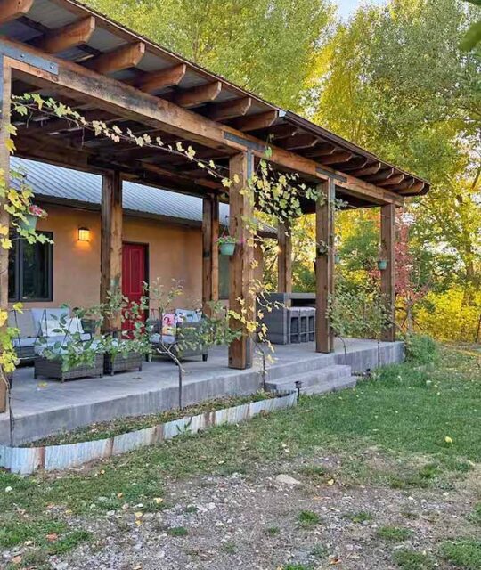 The front porch of a vacation rental with fall colors.