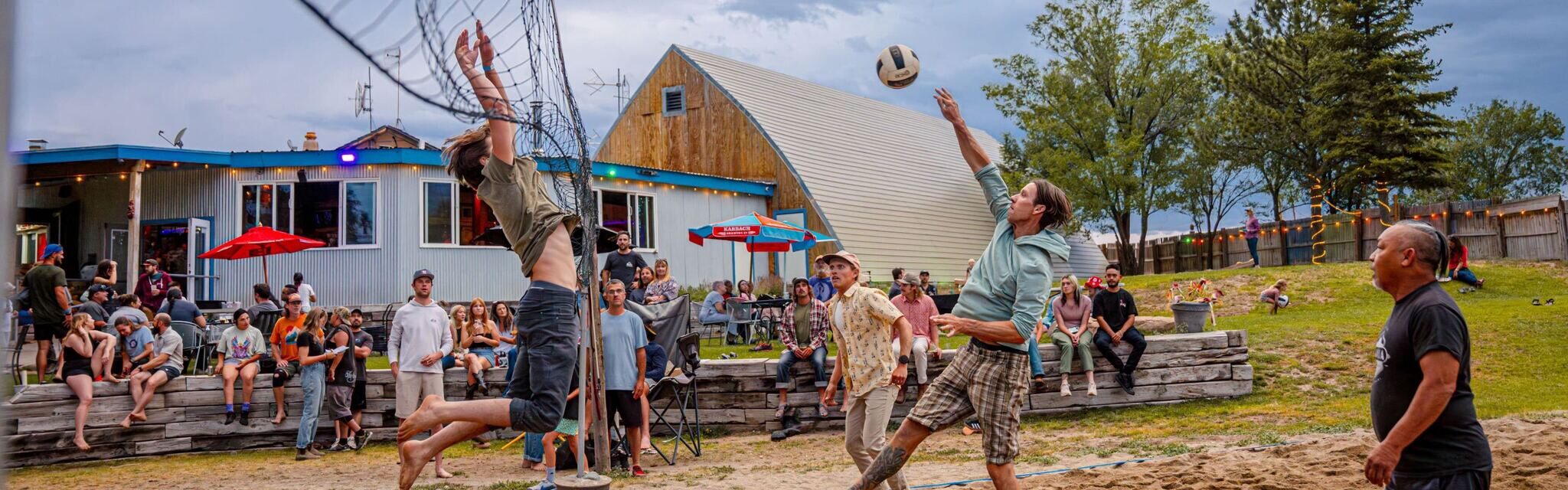 People playing volleyball on the sand