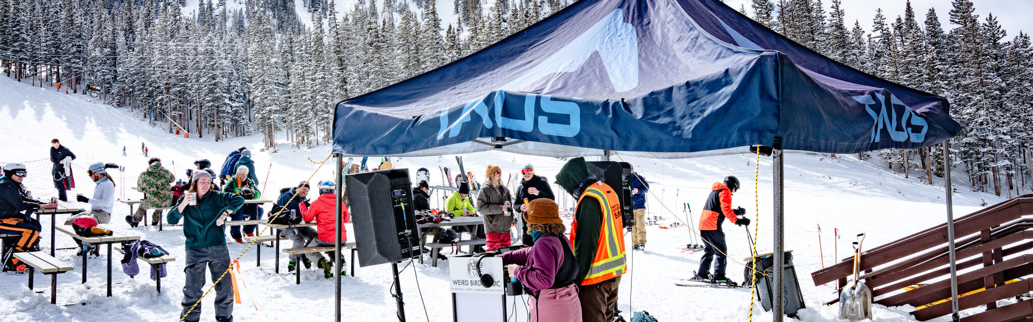 Person dancing with DJs playing music in the snow